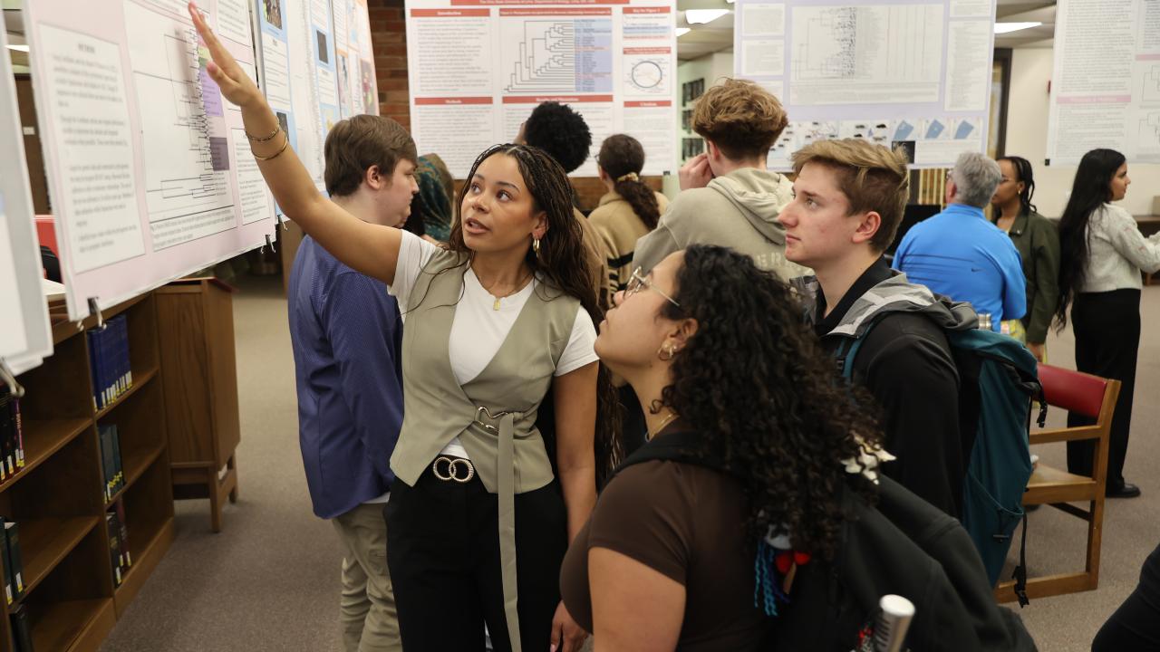 A student researcher explains her project